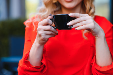 female hands holding a cup of coffeeの写真素材