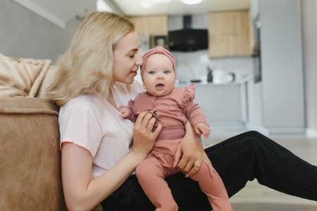 Portrait of young mother with cute baby at home