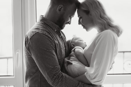 View at Happy family with newborn baby by the window
