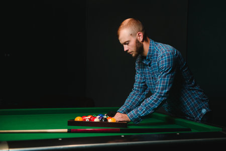 Man playing billiards in a club
