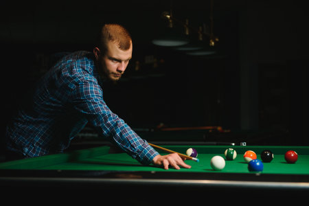 Man playing billiards in a clubの写真素材
