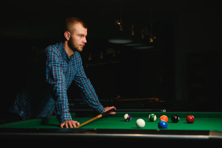 Man playing billiards in a clubの写真素材