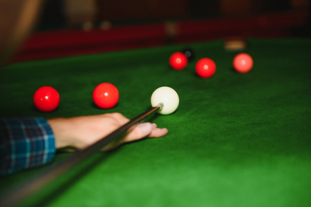 portrait of a young man playing billiards