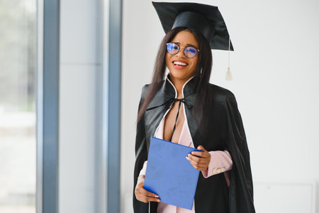 African American graduate holding diploma.の写真素材