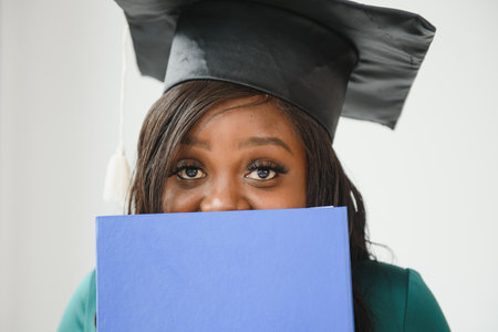 African American graduate holding diploma.の写真素材