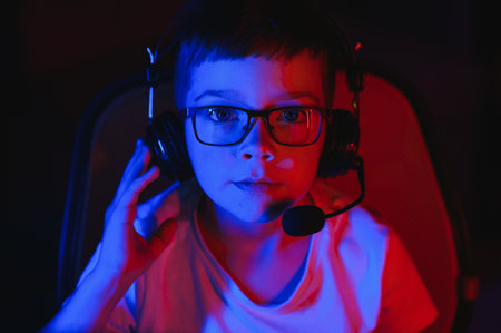 Boy in the headphones is playing a game.の写真素材