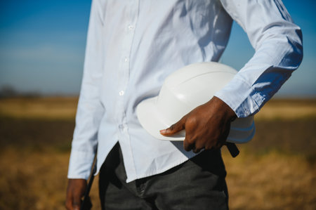 African American worker in a construction helmet