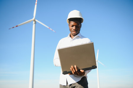 Engineer African man standing with wind turbine