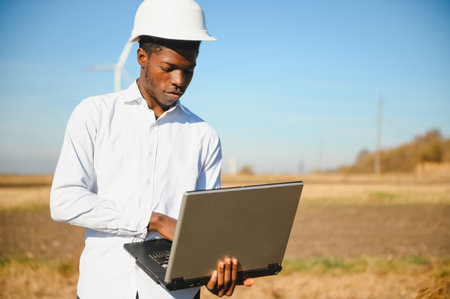 Engineer African man standing with wind turbine