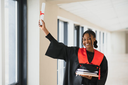 beautiful young afro american graduate holding diploma