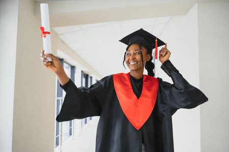 beautiful african female student with graduation certificateの写真素材