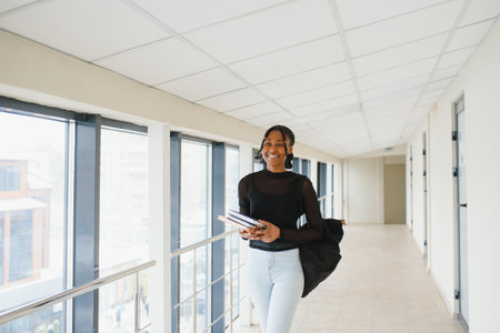 Young african american student girl smiling happy walking at university campus.