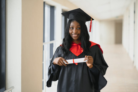beautiful african female student with graduation certificateの写真素材
