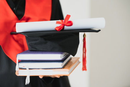 beautiful african female student with graduation certificateの写真素材