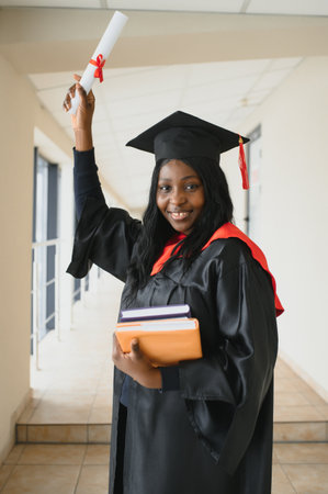 beautiful young afro american graduate holding diploma