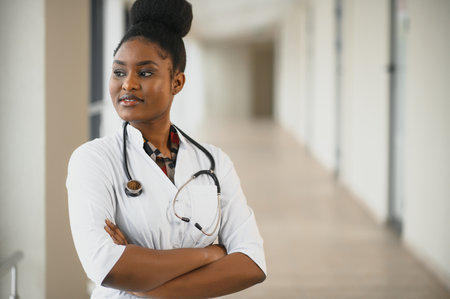 Closeup portrait of friendly, smiling confident female healthcare professional with lab coat, stethoscope. Isolated hospital clinic background. Time for an office visitの写真素材