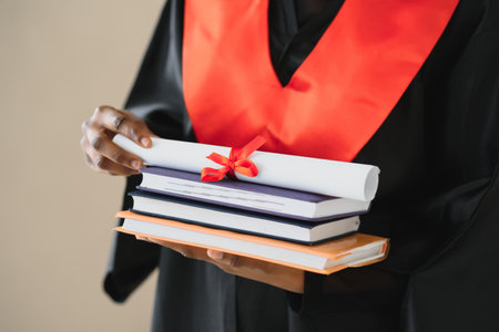 Closeup portrait of happy female student with certificate in college campusの写真素材