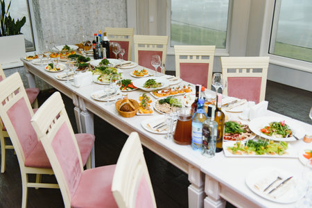 beautifully laid tables with glasses and appliances at morning in restaurant.
