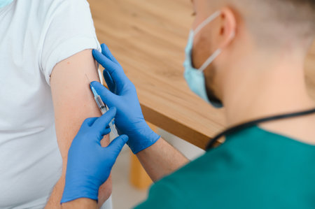 Doctor making a vaccination in the shoulder of patient Disabled person, Flu Vaccination Injection on...