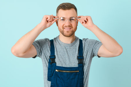 Handsome young craftsman over isolated blue backgroundの写真素材