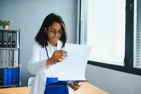 happy young african female nurse working in officeの写真素材