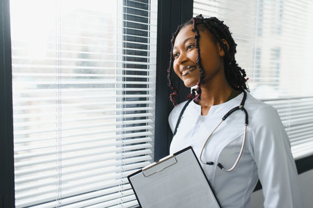 Portrait Of Female Doctor Wearing White Coat In Officeの写真素材