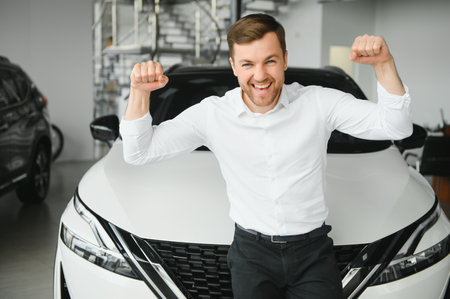 Man buying a car at a showroom.の写真素材