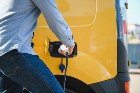 Smiling man unplugging the charger from the car.