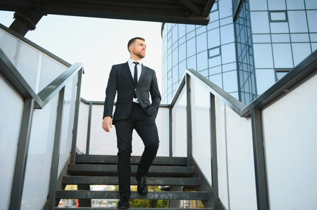 Portrait of a smiling businessman in a modern business environment.の写真素材