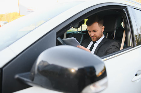 Attractive elegant happy man in good car.