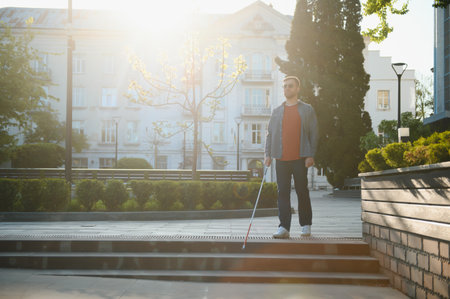 Blind Man Walking On Sidewalk Holding Stick.の写真素材