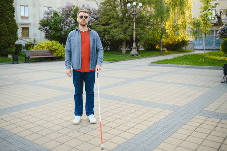 Close-up Of A Blind Man Standing With White Stick On Street.の写真素材