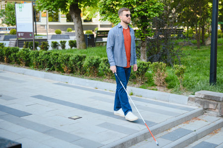 Blind Man Walking On Sidewalk Holding Stick.の写真素材