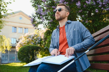 Blinded man reading by touching braille book.の写真素材