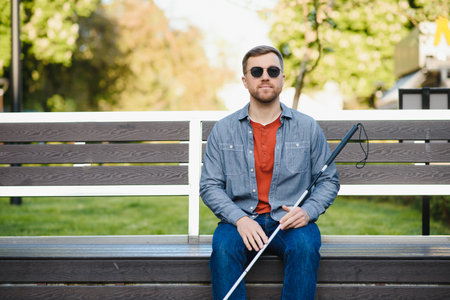 blind man sitting on a bench.の写真素材