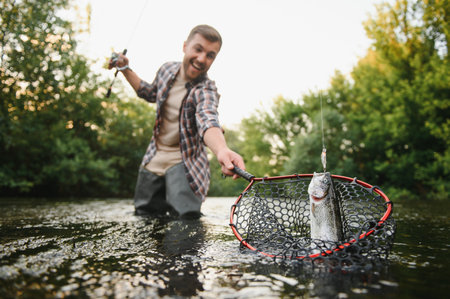 Fishing. Fisherman and trout. Fisherman on wild river