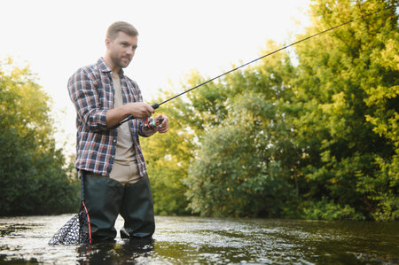 Fishing. Fisherman and trout. Fisherman on wild riverの写真素材