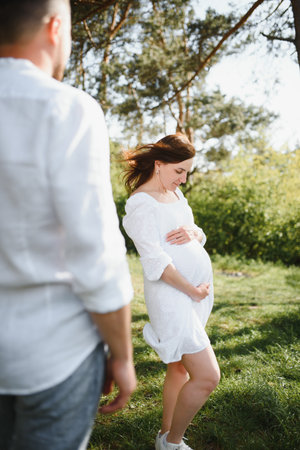 Pregnant woman with her family looking happy.の写真素材