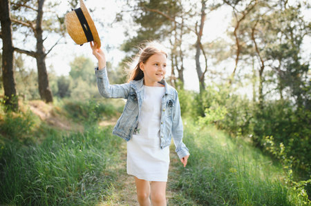 Funny cute child girl in park over nature background. Happiness. summer seasonの写真素材