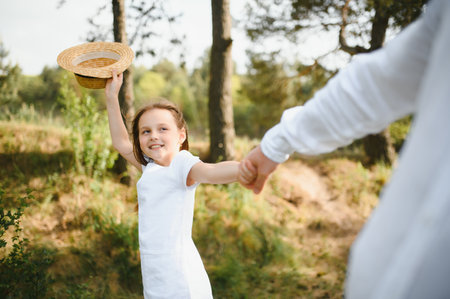 stylish bearded father with his little daughter walk in the summer parkの写真素材