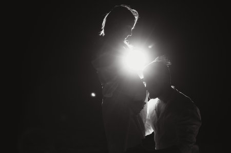 Happy Pregnant Couple. Mother and Father Love expecting Baby during Pregnancy. Family waiting Child Birth over Black Night Background.の写真素材