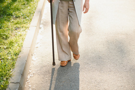 Senior woman walking in the park in summerの写真素材