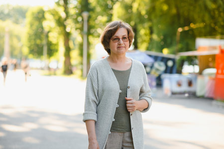Portrait of a happy senior woman in summer park.