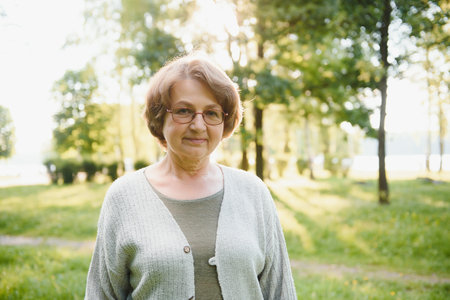Senior woman walking in the park in summer