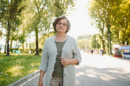 Portrait of a happy senior woman in summer park.の写真素材