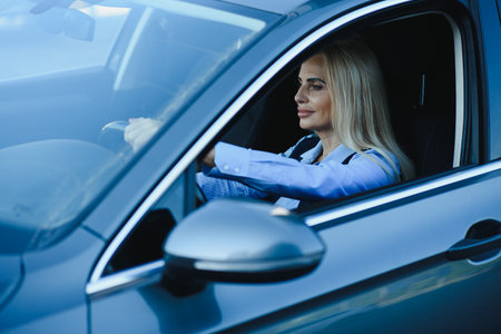 Portrait of business elegant middle-aged woman in car