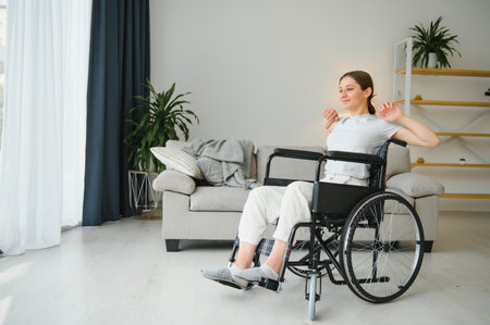 Brunette woman working out on wheelchair at home.