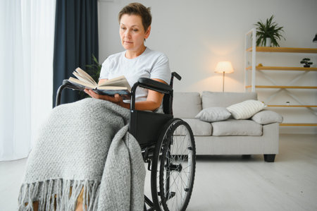 middle aged woman sitting on a wheelchair.の写真素材