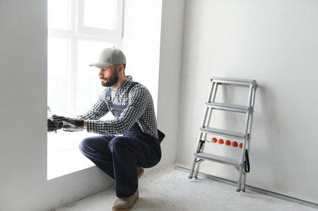 Young worker making repair in room.の写真素材