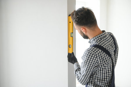 Young worker making repair in room.の写真素材